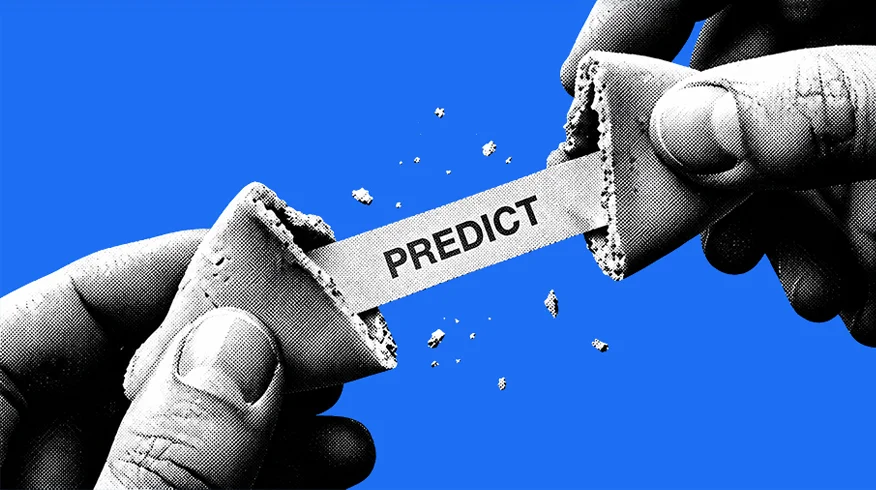 Black-and-white hands breaking open a fortune cookie with a slip marked PREDICT, against blue.